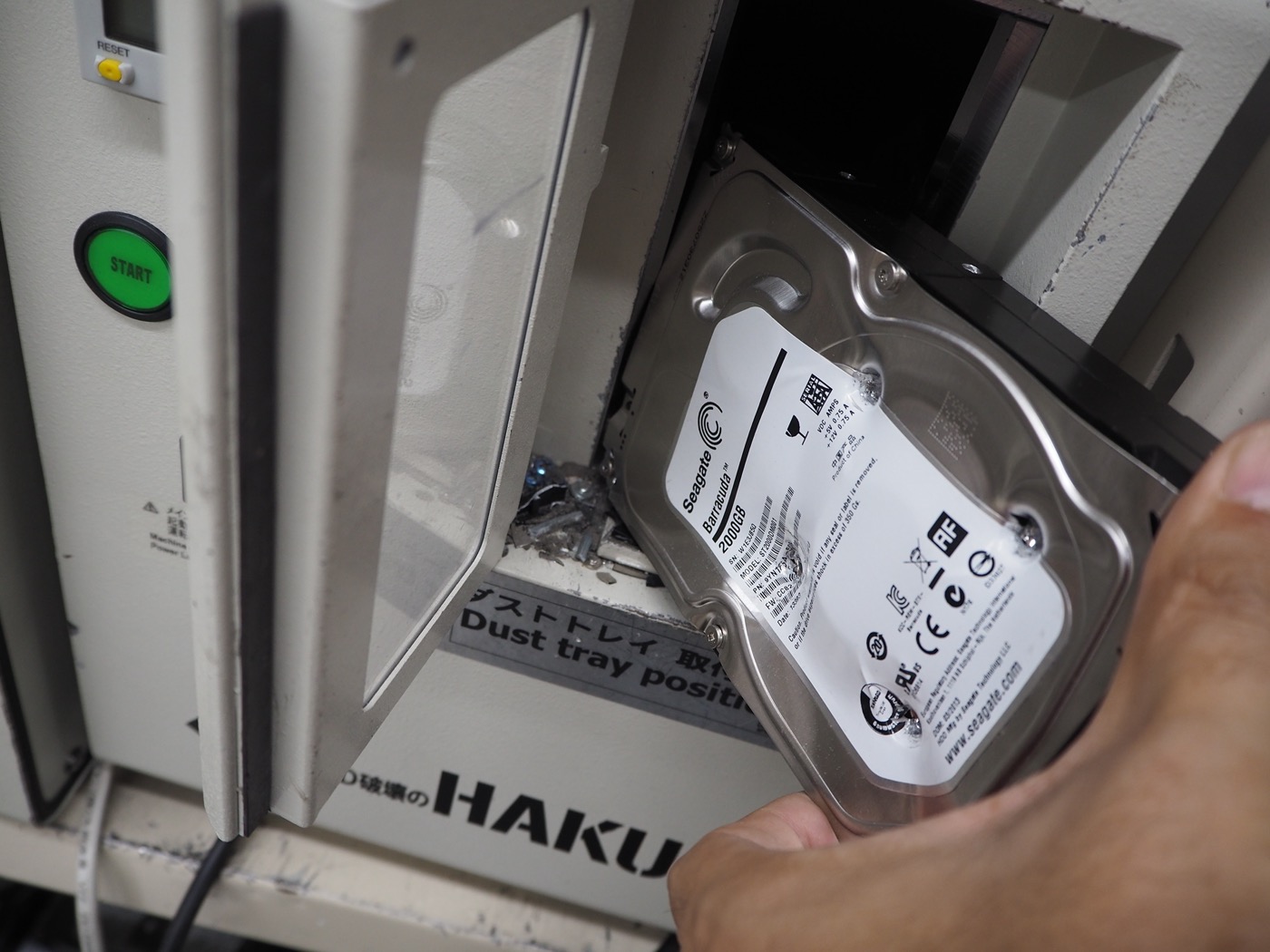 HDD破壊機に投入する作業風景